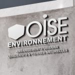 Enseigne Oise Environnement sur fond de béton
