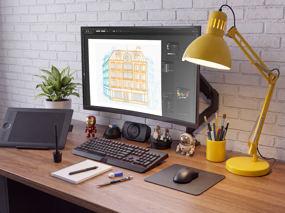 Aujourd’hui : le poste du graphiste sur écran Même bureau avec un écran affichant l'illustration d'une façade dans un logiciel de dessin, tablette graphique, clavier, souris et la même lampe jaune.